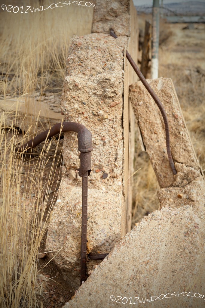 A pipe is "connected" to a piece of rebar from the original still wall.