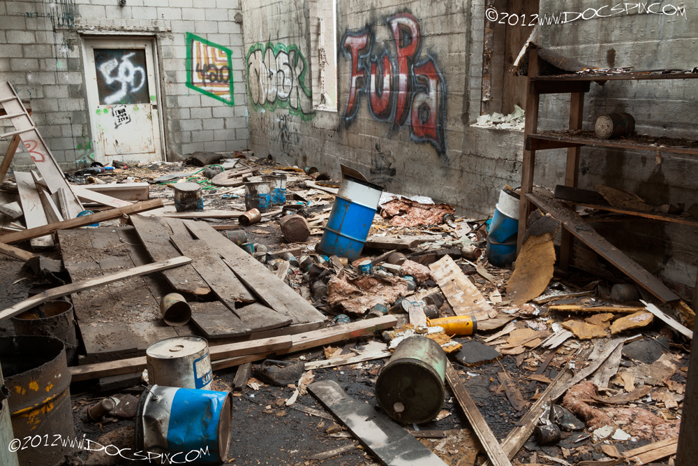 Inside the middle production building, looking west. Note the block wall on the left, and the poured concrete wall on the right. 