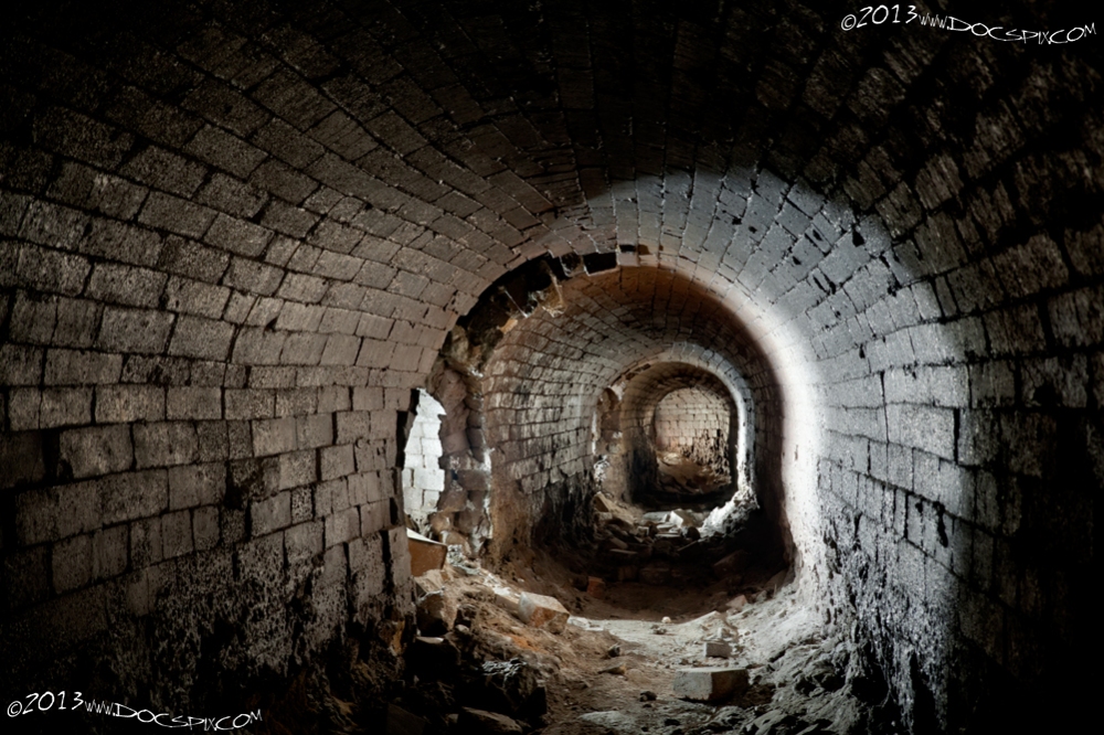 A view of the last three flues. Although the tunnels were made of brick, the tremendous heat generated glazed the surface of the brick. There was probably some hot oil that was included in the exhaust; note the lower portions of the walls have bricks that appear to be melted.