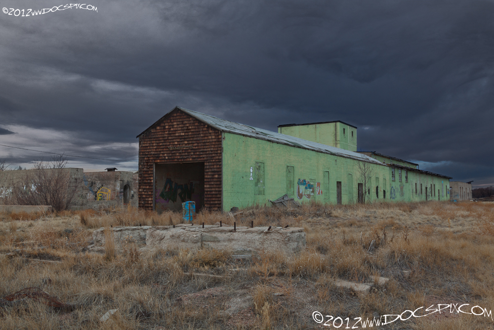 The north production line. The third building has a pitched roof, the second and transitional buildings have a flat roof. The transitional building has three windows higher than the others. 