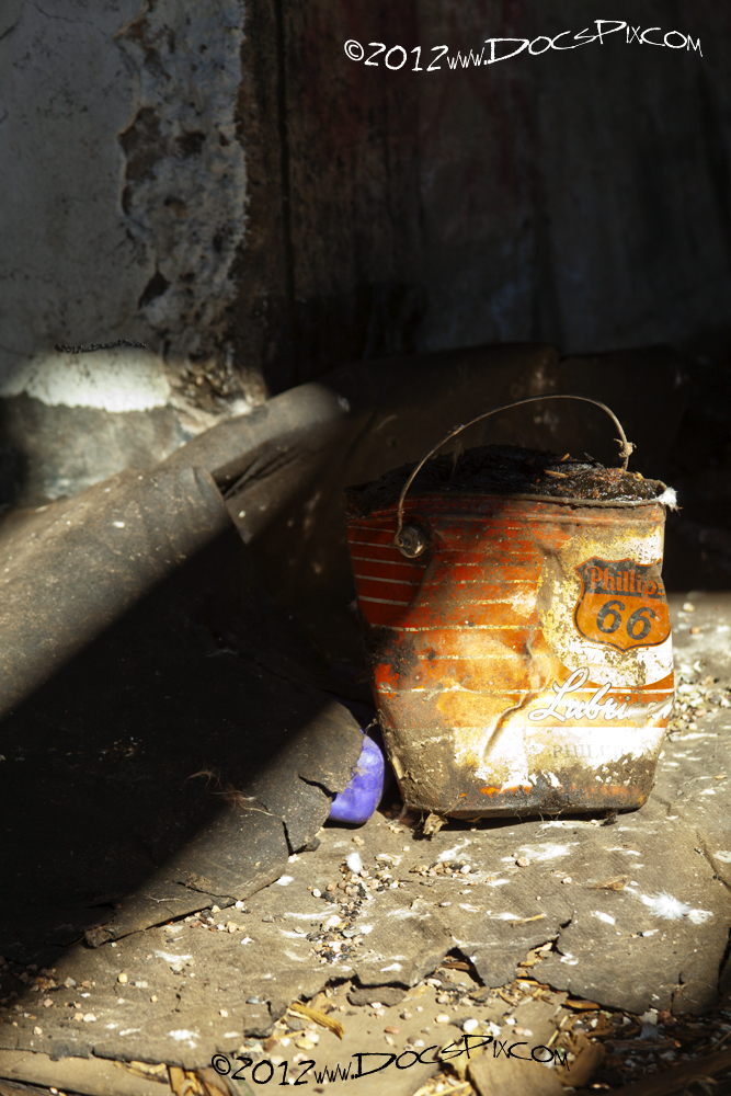 An old grease can rests on the floor. 