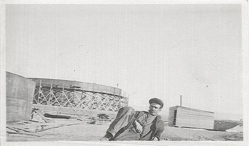 An unidentified worker takes a break near the tank farm as its being constructed. 