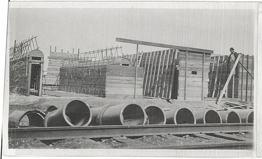 The forms that make up the still foundations are seen here in various stages of completion. The steel bars are made of twisted steel to provide additional support for the concrete. 