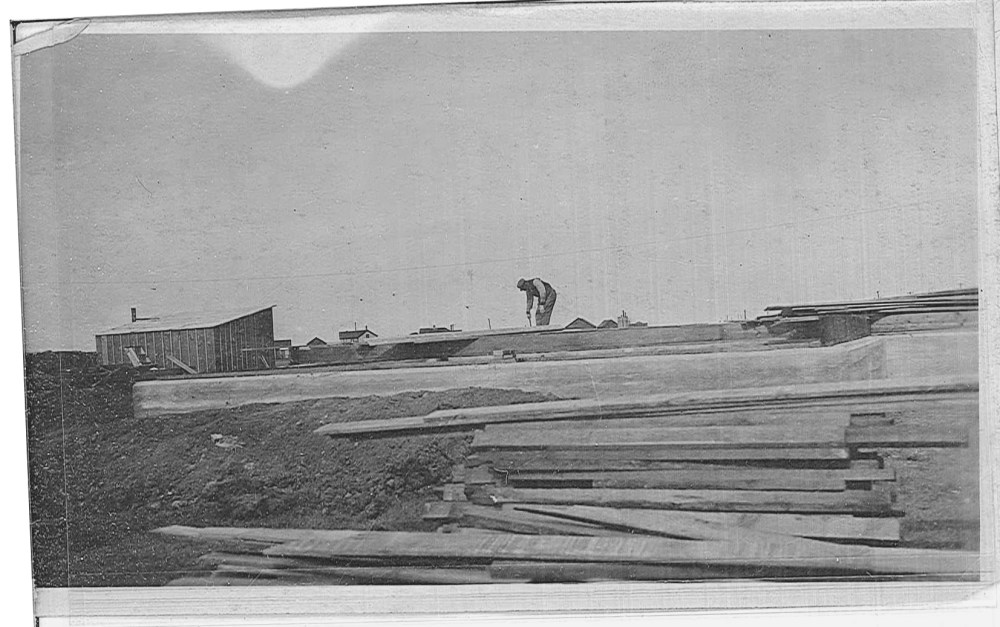A worker prepares one of the concrete forms. 